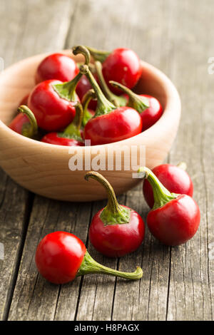 Piment rouge dans un bol sur la table en bois. Banque D'Images