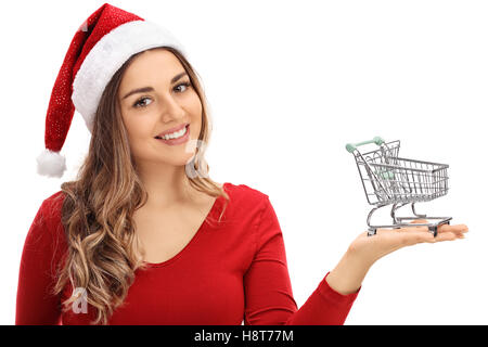 Happy young woman with a Christmas hat tenant un petit vide panier isolé sur fond blanc Banque D'Images