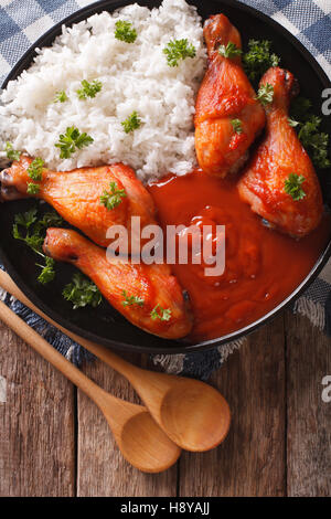 Les cuisses de poulet avec sauce Sriracha et le riz sur la table. Vue verticale d'en haut Banque D'Images