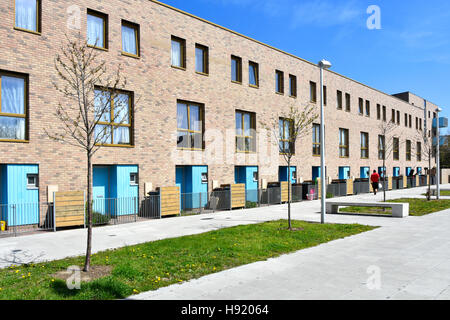 Vue avant du longue rangée de maisons de ville moderne avec terrasse dans une rue résidentielle dans le cadre de nouveau développement Barking Riverside East London England UK Banque D'Images