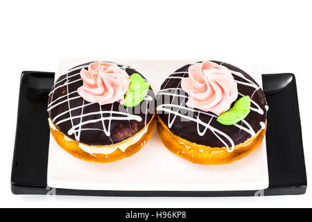 Gâteaux biscuits colorés avec du glaçage de bush et sa crème anglaise le remplissage. Studio Photo Banque D'Images