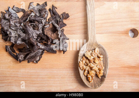 Corne de l'abondance sur les champignons en bois planche à découper avec cuillère en bois de noyer complète Banque D'Images