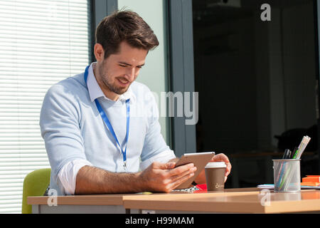 Young businessman in office using digital tablet Banque D'Images