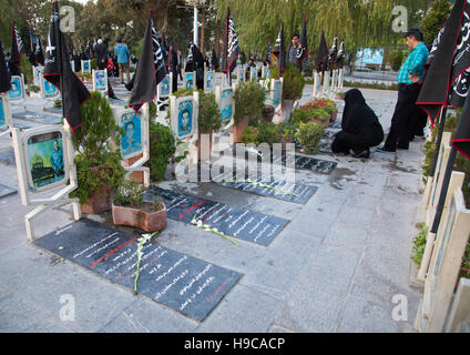 Famille prier sur la tombe de leur fils tué dans la guerre en Irak l'Iran la roseraie de cimetière des martyrs, province d'Ispahan, Isfahan, Iran Banque D'Images