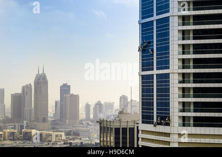 Les rondelles lavez les fenêtres des gratte-ciel modernes à Dubaï Banque D'Images