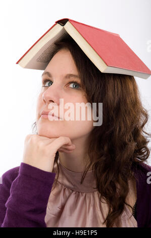 Jeune femme avec un livre sur la tête. Banque D'Images