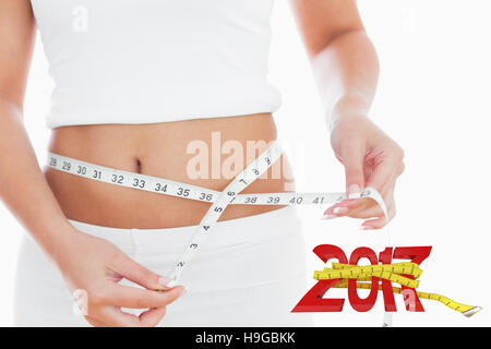 Image composite de midsection of woman measuring waist Banque D'Images
