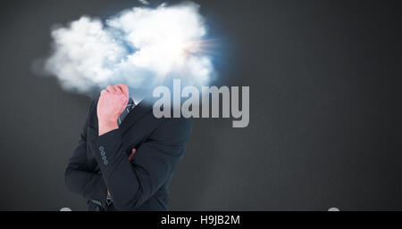 Composite image of businessman standing with hand on chin Banque D'Images