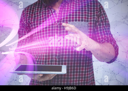 Image composite de mid section of man gesturing tandis que holding digital tablet Banque D'Images
