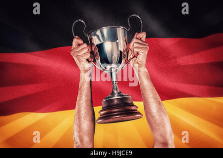 Image composite de portrait of smiling rugby player holding trophy Banque D'Images
