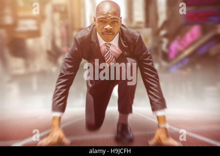 Composite image of businessman in starting blocks Banque D'Images