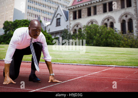Composite image of businessman in starting blocks Banque D'Images