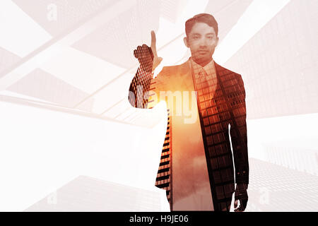 Image composite de stern asian businessman Banque D'Images