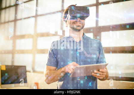 Homme d'affaires dans la région de casque de réalité virtuelle using digital tablet Banque D'Images