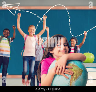 Image composite de l'élève cute smiling holding globe Banque D'Images