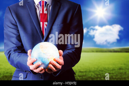 Composite image of businessman holding globe terrestre Banque D'Images