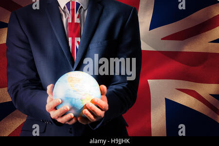 Composite image of businessman holding globe terrestre Banque D'Images