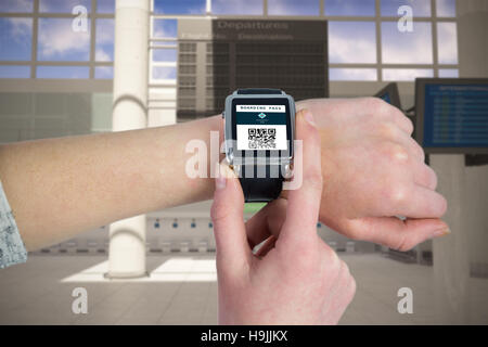 Composite image of woman using smartwatch Banque D'Images