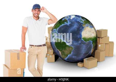 Composite image of delivery man leaning on trolley de boîtes Banque D'Images