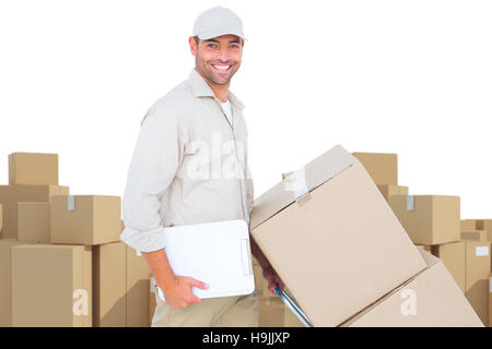 Image composite de livraison man pushing trolley de cases sur fond blanc Banque D'Images