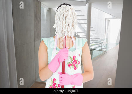 Image composite de femme cachant son visage avec un mop Banque D'Images