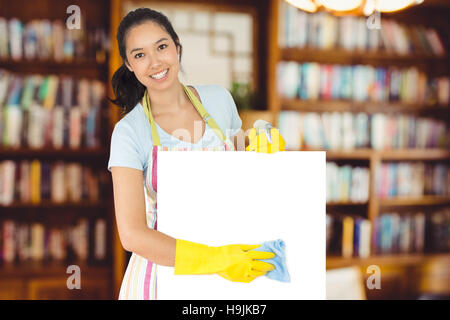 Composite image of woman wiping surface blanche vers le bas Banque D'Images