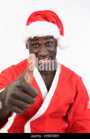 Dark-skinned Santa Claus holding thumb up Banque D'Images