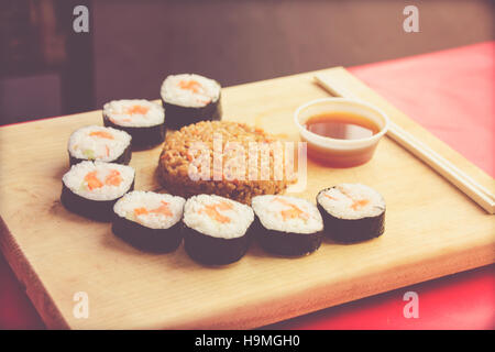 Phtograph de certaines tranches Sushi roll riz frit et sur une table en bois Banque D'Images