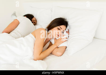 Jeune couple sleeping in bed Banque D'Images