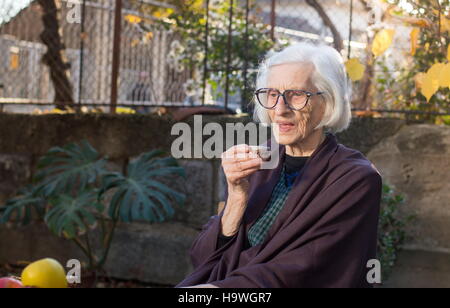 Senior woman having tasse de café en plein air Banque D'Images