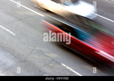 Deux voitures vitesse excessive sur la rue dans le motion blur Banque D'Images