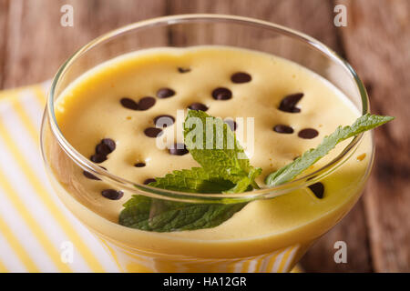 Crème d'oeufs au chocolat Zabaione gouttes et la menthe dans un verre horizontal macro. Banque D'Images