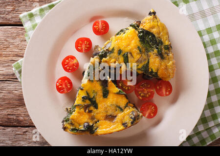 Frittata aux épinards et champignons sur une plaque horizontale. close-up Vue de dessus Banque D'Images