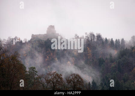 Ruines du château de Smlednik mystérieux au sommet d'une colline, le théâtre de la fin de l'automne, le brouillard Banque D'Images