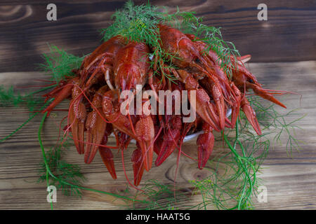 Assiette de bouillie rouge aux écrevisses avec pinces et fenouil sur fond de bois Banque D'Images