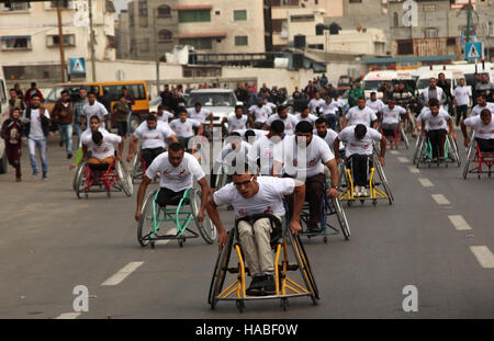 La ville de Gaza, bande de Gaza, territoire palestinien. 29 Nov, 2016. Les hommes palestiniens sur les fauteuils roulants à participer à un marathon organisé pour les Palestiniens qui ont été blessés à la suite de guerres, dans la ville de Gaza. Des dizaines de milliers d'habitants de Gaza sont en train d'apprendre à faire face à l'invalidité ou parties perdues après les trois guerres entre les militants palestiniens dans les territoires et Israël depuis 2008 © Ashraf Amra/APA/Images/fil ZUMA Alamy Live News Banque D'Images