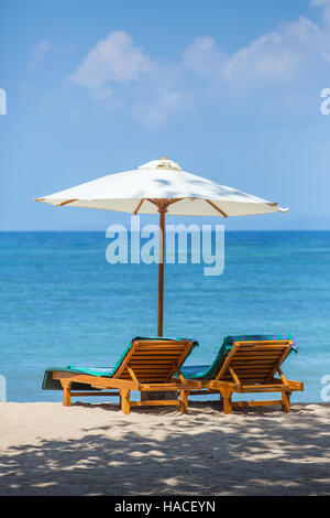 Deux chaises longues avec parasol sur une plage Banque D'Images