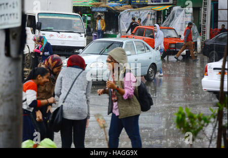 Le Caire, Égypte. Dec 12, 2015. Les Egyptiens à pied à la rue sous la pluie et une vague de froid sur plus de pays et la capitale du Caire (Égypte) le 1 décembre 2016 © Amr Sayed/APA/Images/fil ZUMA Alamy Live News Banque D'Images