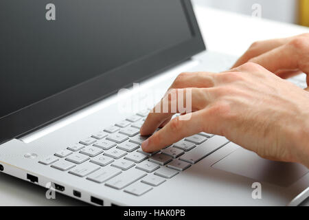 Hands typing on laptop keyboard Banque D'Images