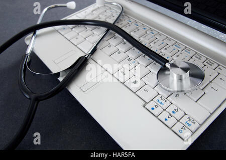 Ordinateur portable et d'un stéthoscope sur le bureau. Concept de diagnostic de l'ordinateur Banque D'Images