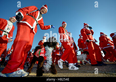 Eastbourne, East Sussex. 4e décembre 2016. La charité Santa courir le long de la mer pour Myaware la charité. Banque D'Images