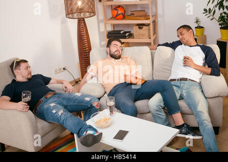 Happy friends resting after party football Banque D'Images