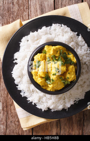 La cuisine indienne : Korma Poulet en sauce coco riz basmati et gros plan sur la table. vertical Vue de dessus Banque D'Images