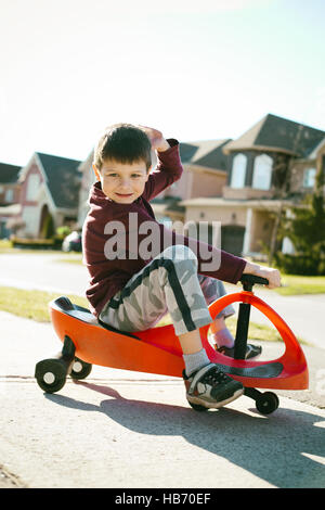 Boy riding scooter Banque D'Images