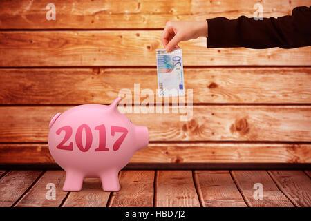 Image composite de businesswomans hand holding twenty euro note Banque D'Images