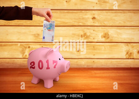 Image composite de businesswomans hand holding twenty euro note Banque D'Images