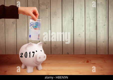 Image composite de businesswomans hand holding twenty euro note Banque D'Images