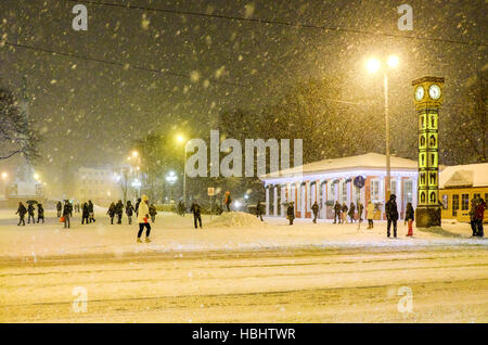 Riga, Lettonie - 3 janvier 2016 : l'hiver neige rues de la vieille ville de Riga et de la célèbre horloge Laima. Banque D'Images