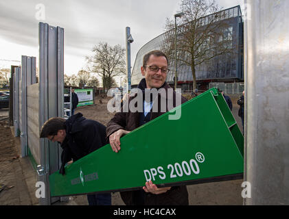 Brême, Allemagne. Le 08 mai 2016. Le ministre de l'économie de Brême Martin Guenthner (SPD) et le président de la Bundesliga allemande soccer club Werder Brême Hubertus Hess-Grunewald (L) aider à assembler la nouvelle barrière de protection contre les inondations mobile lors d'une manifestation devant le stade Weser à Brême, Allemagne, 08 décembre 2016. Le mur est conçu pour compléter une deuxième, mur permanent autour du stade de foot en cas de crues éclair. Photo : Ingo Wagner/dpa/Alamy Live News Banque D'Images