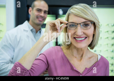 La clientèle féminine portant des lunettes en magasin optique Banque D'Images